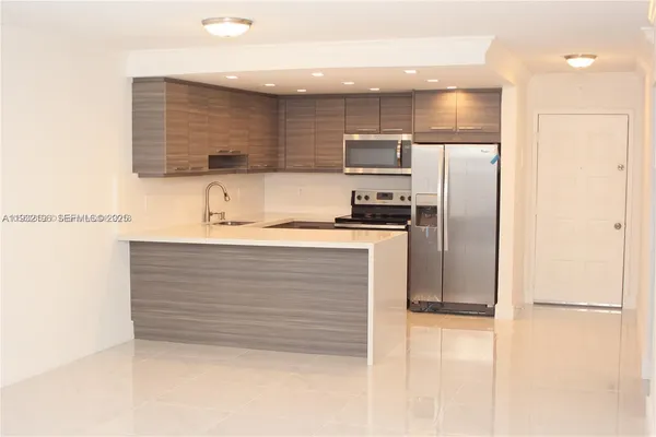 a kitchen with a refrigerator and a sink