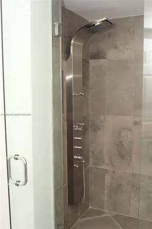 a bathroom with a glass shower door