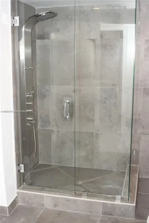 a bathroom with a glass shower door