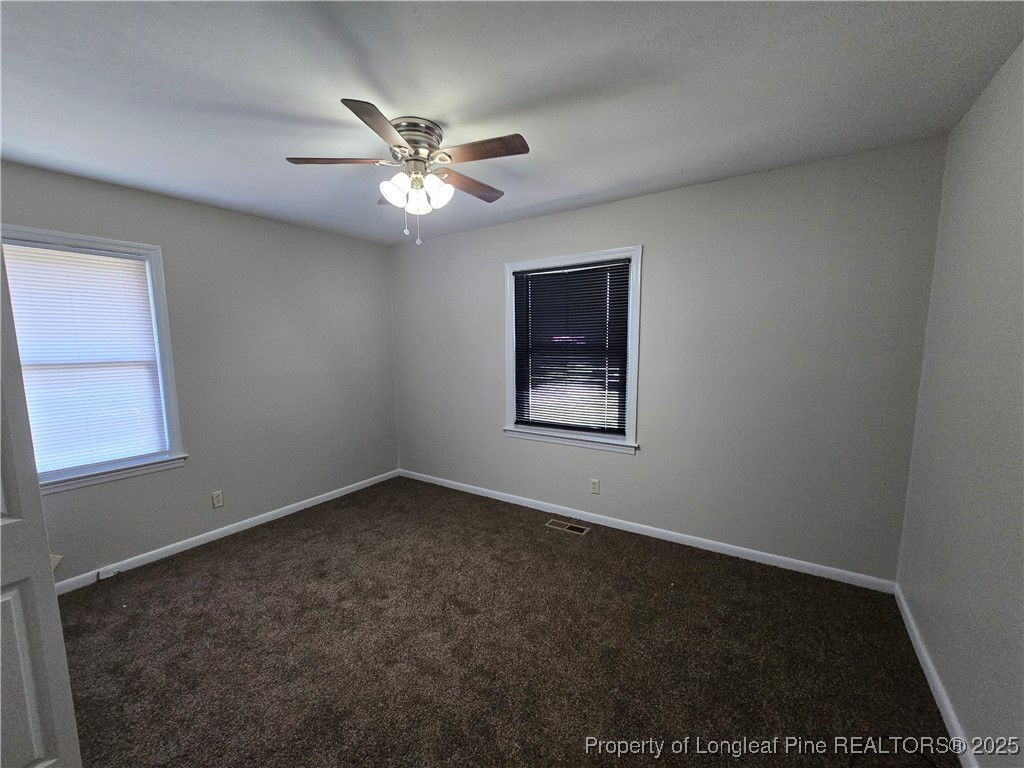 4617 Belford Road Fayetteville, NC 28314 - Photo 16 of 21 an empty room with windows and fan