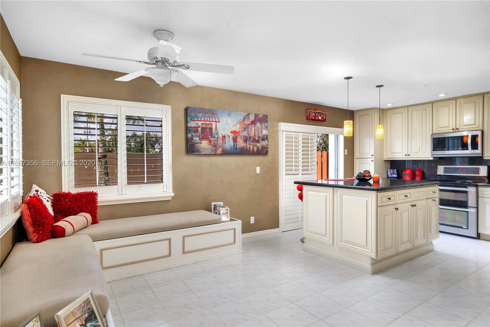 11360 Rockinghorse Road Cooper City, FL 33026 - Photo 11 of 31 a living room with stainless steel appliances kitchen island granite countertop furniture and a flat screen tv