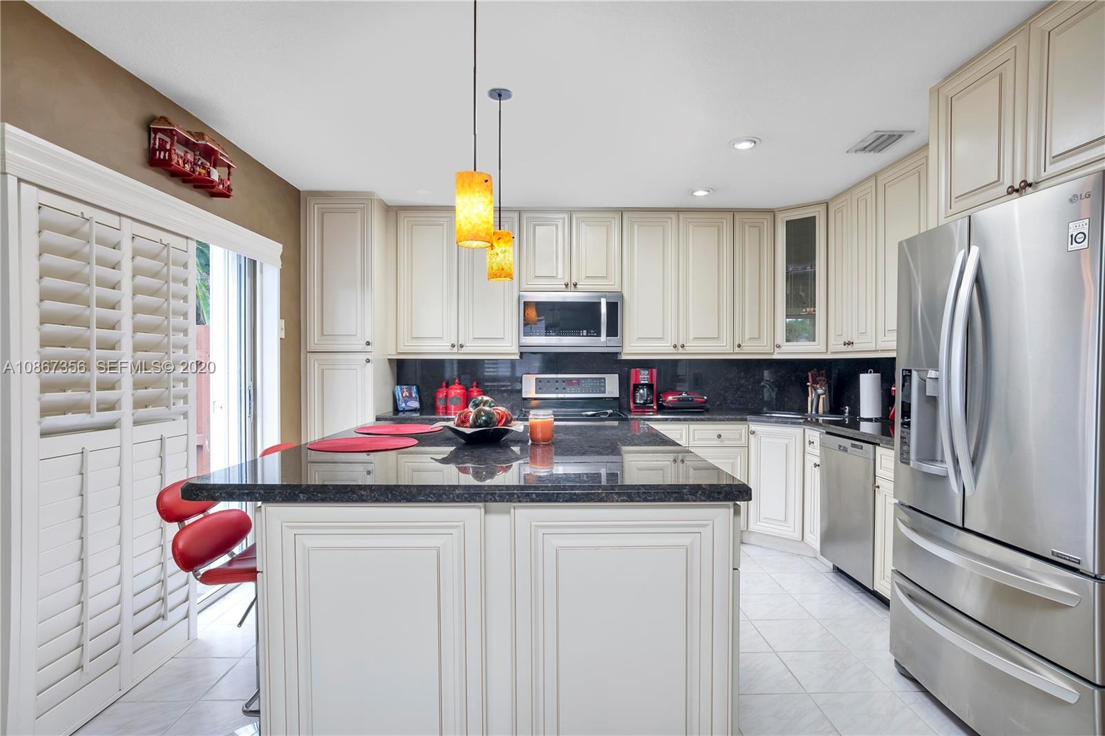 11360 Rockinghorse Road Cooper City, FL 33026 - Photo 12 of 31 a kitchen with a refrigerator and a sink