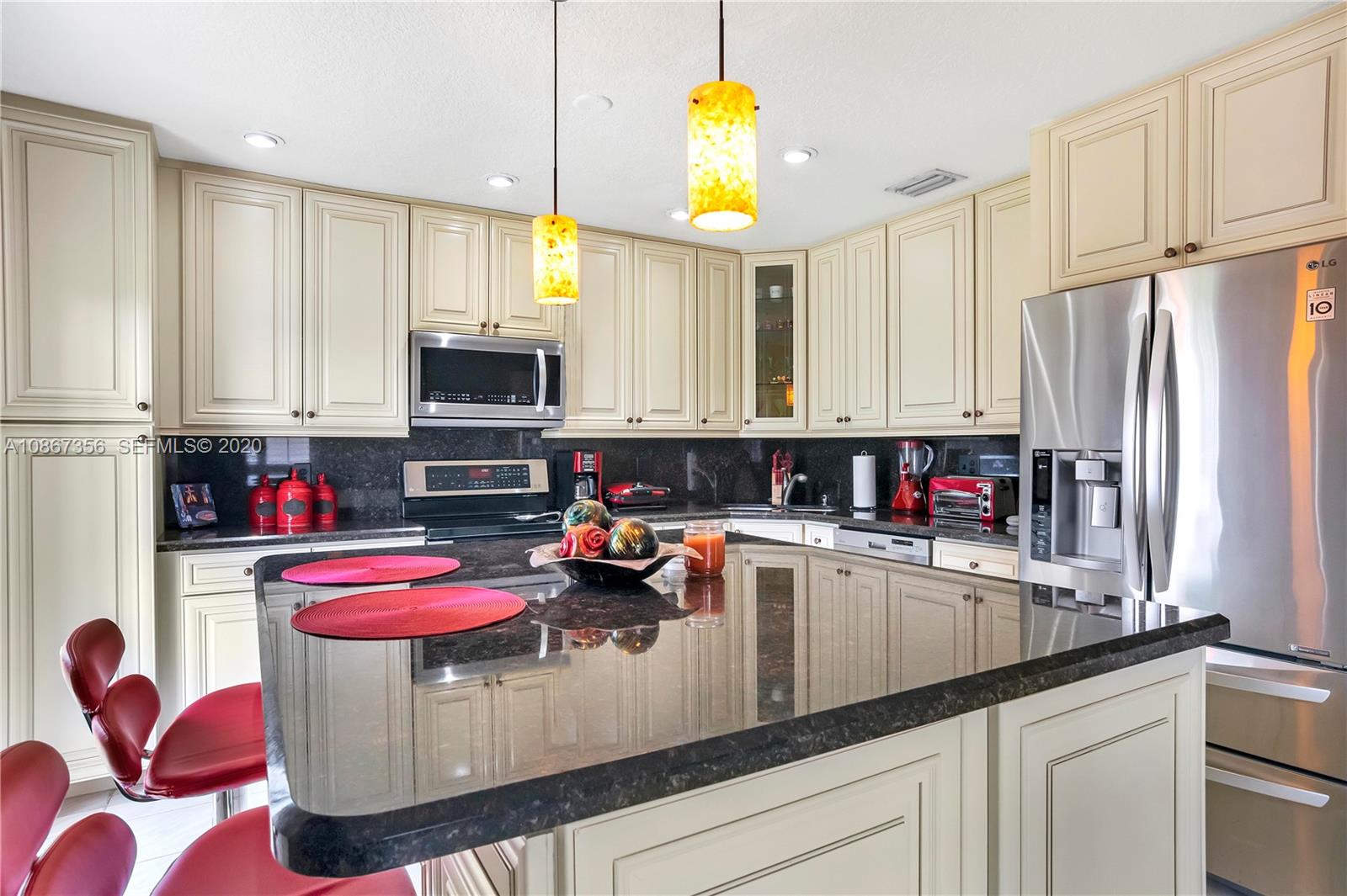 11360 Rockinghorse Road Cooper City, FL 33026 - Photo 13 of 31 a kitchen that has a lot of cabinets and appliances
