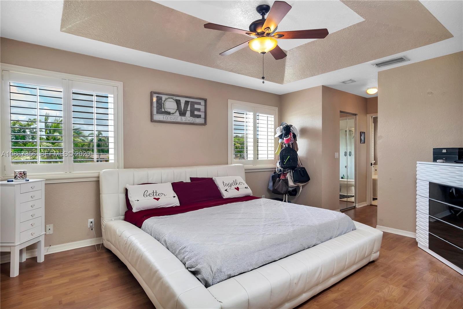 11360 Rockinghorse Road Cooper City, FL 33026 - Photo 19 of 31 a bed room with a bed and a chandelier