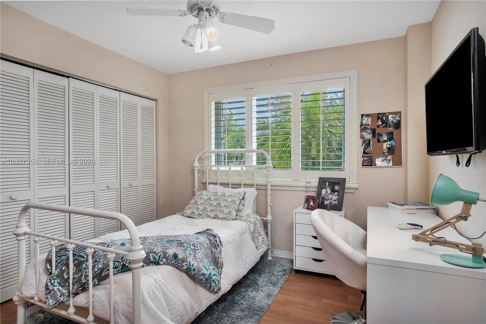 11360 Rockinghorse Road Cooper City, FL 33026 - Photo 20 of 31 a bedroom with a bed and a flat screen tv
