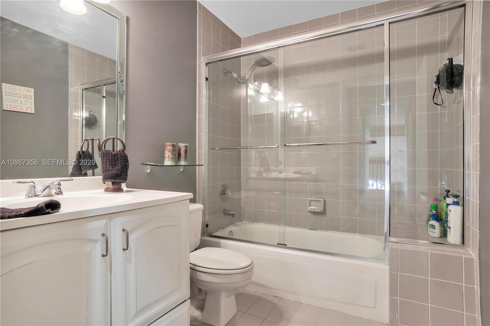 11360 Rockinghorse Road Cooper City, FL 33026 - Photo 22 of 31 a bathroom with a shower sink vanity mirror and toilet
