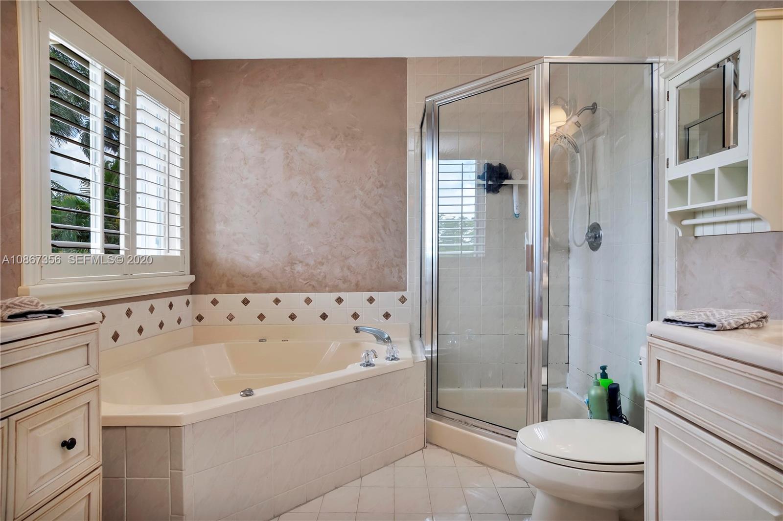 11360 Rockinghorse Road Cooper City, FL 33026 - Photo 23 of 31 a bathroom with a bathtub toilet and shower