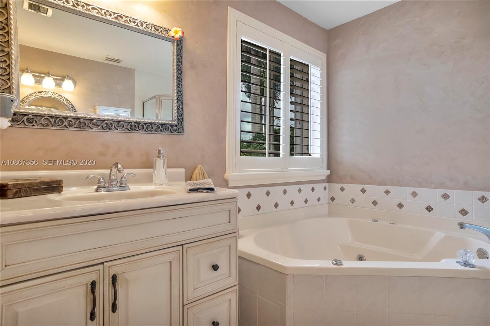 11360 Rockinghorse Road Cooper City, FL 33026 - Photo 24 of 31 a bathroom with a bathtub and a sink