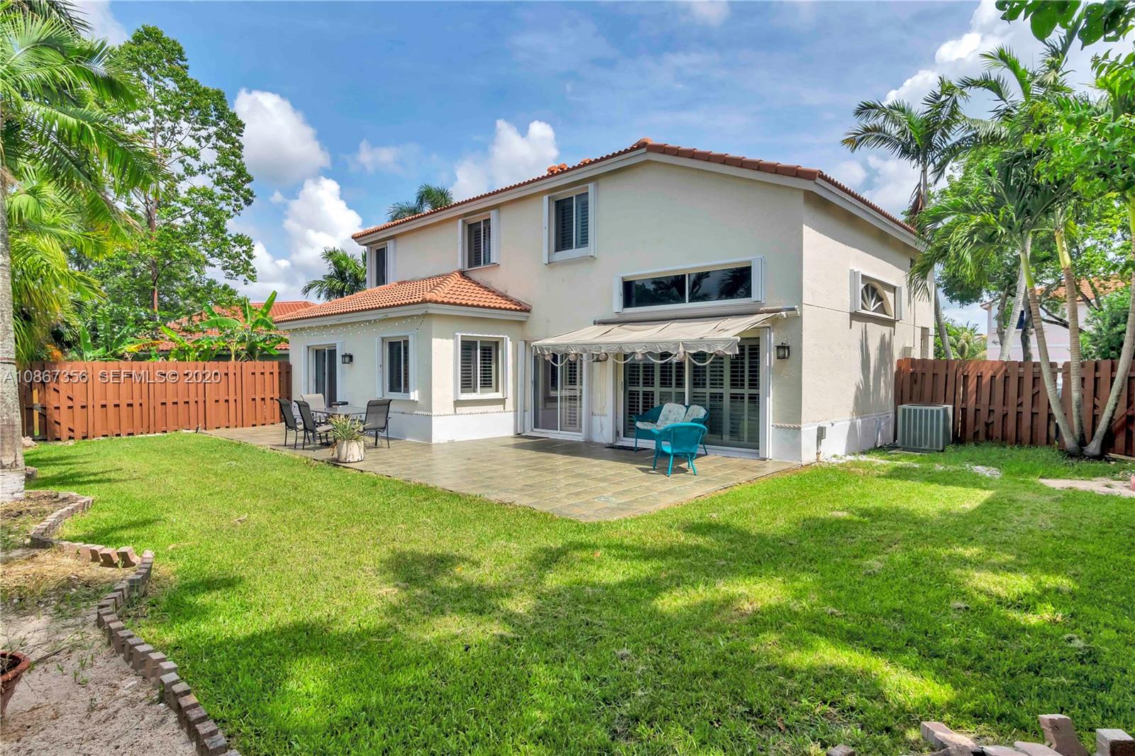 11360 Rockinghorse Road Cooper City, FL 33026 - Photo 28 of 31 front view of a house with a yard