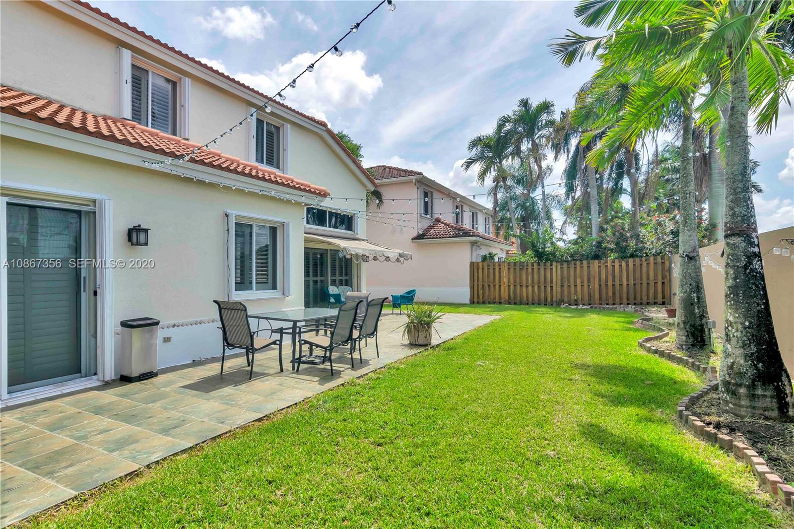11360 Rockinghorse Road Cooper City, FL 33026 - Photo 30 of 31 a backyard of a house with table and chairs