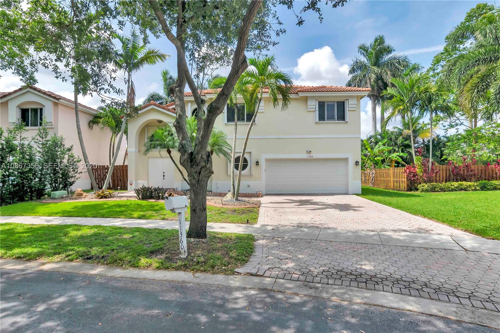 11360 Rockinghorse Road Cooper City, FL 33026 - Photo 5 of 31 a front view of a house with garden