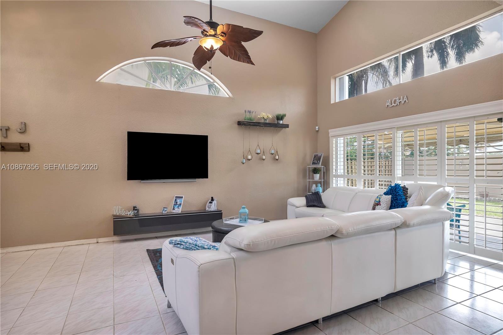 11360 Rockinghorse Road Cooper City, FL 33026 - Photo 8 of 31 a living room with furniture and a flat screen tv