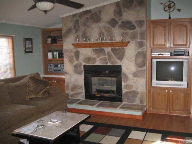 533 Powhatan Road Clayton, NC 27527 - Photo 2 of 12 Great family room with stone fireplace and built ins.