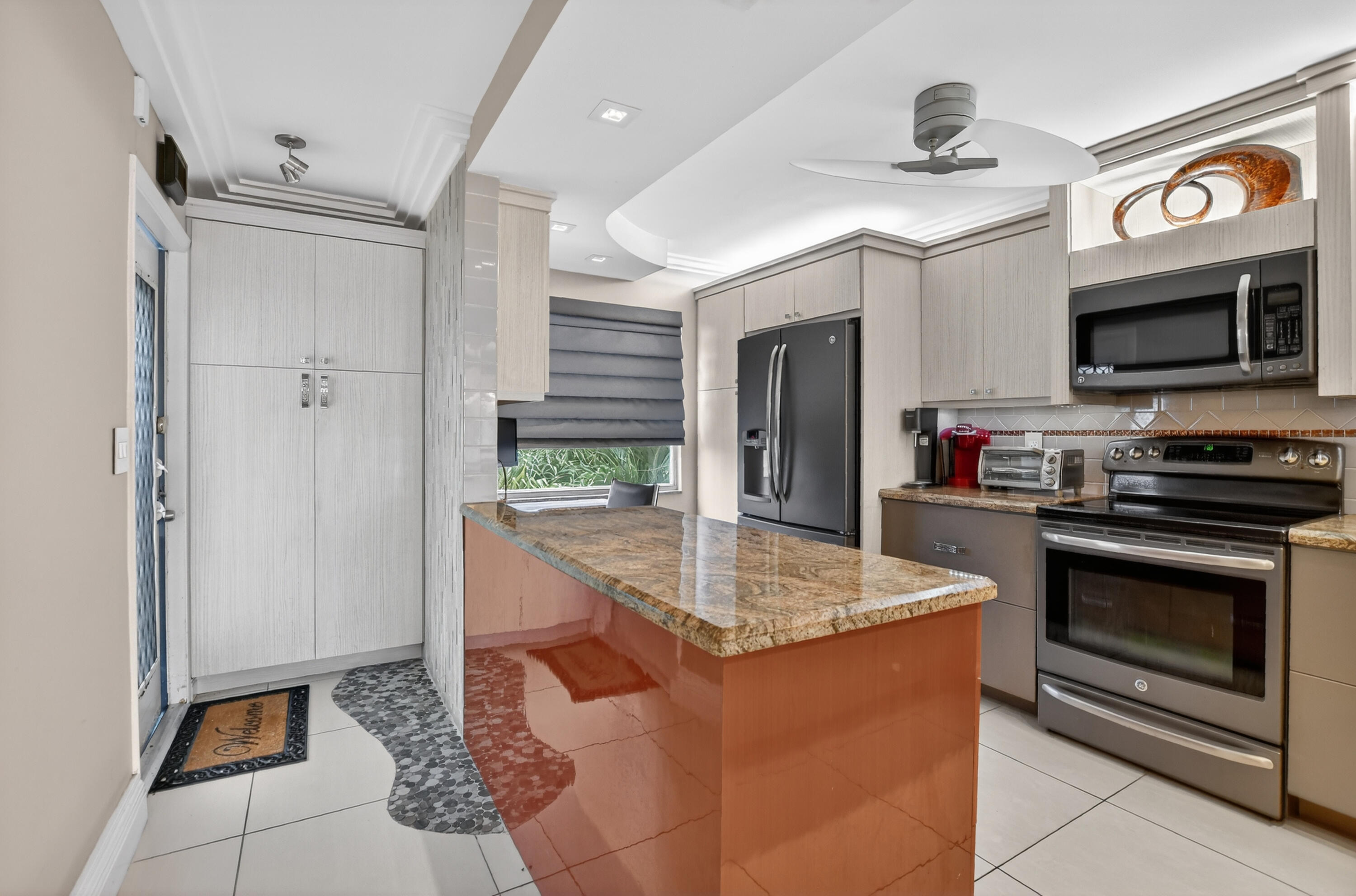 a kitchen with stainless steel appliances granite countertop a sink and a refrigerator