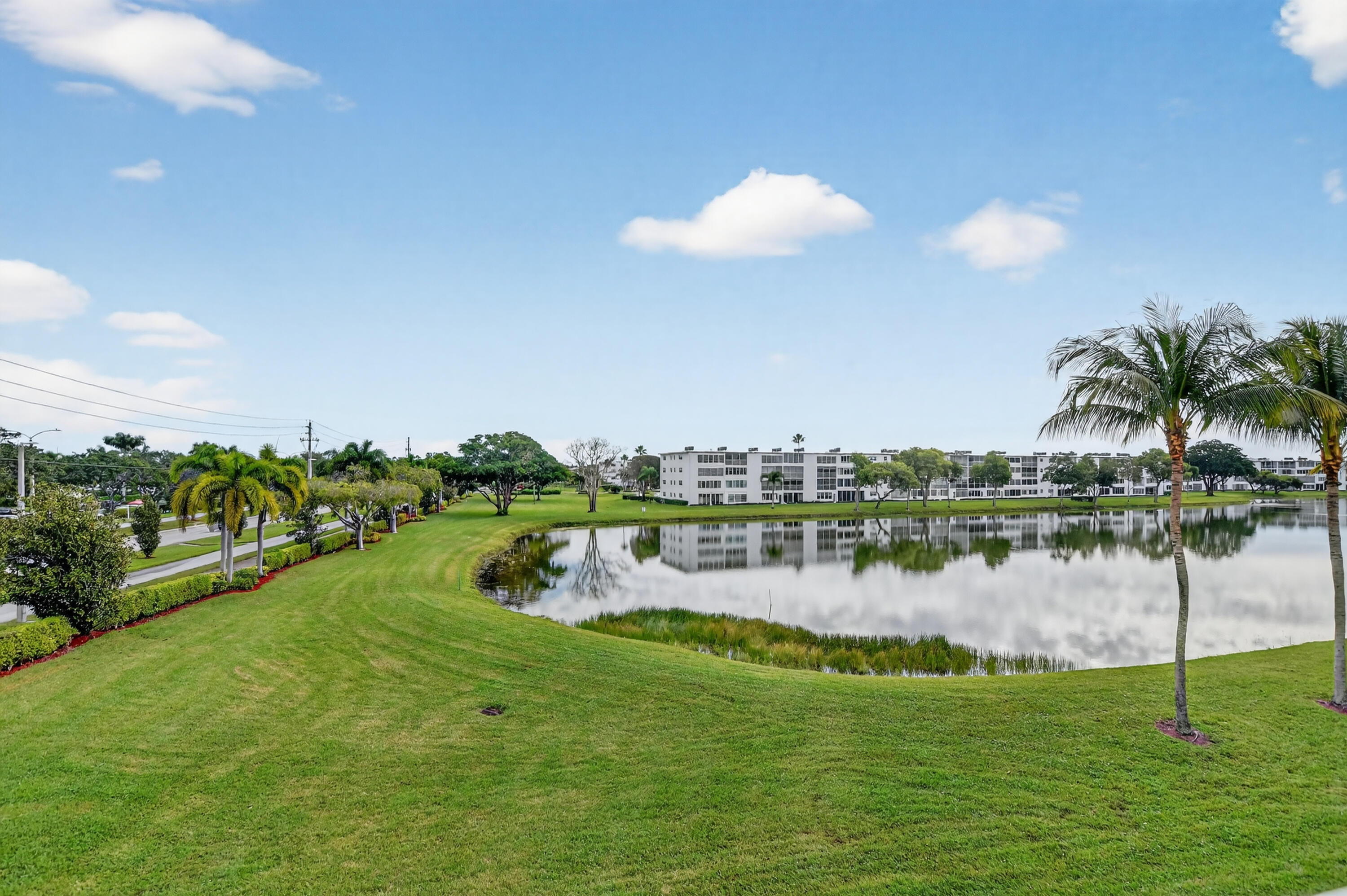 3080 Yarmouth C Boca Raton, FL 33434 - Photo 17 of 83 a view of a lake with houses in the back