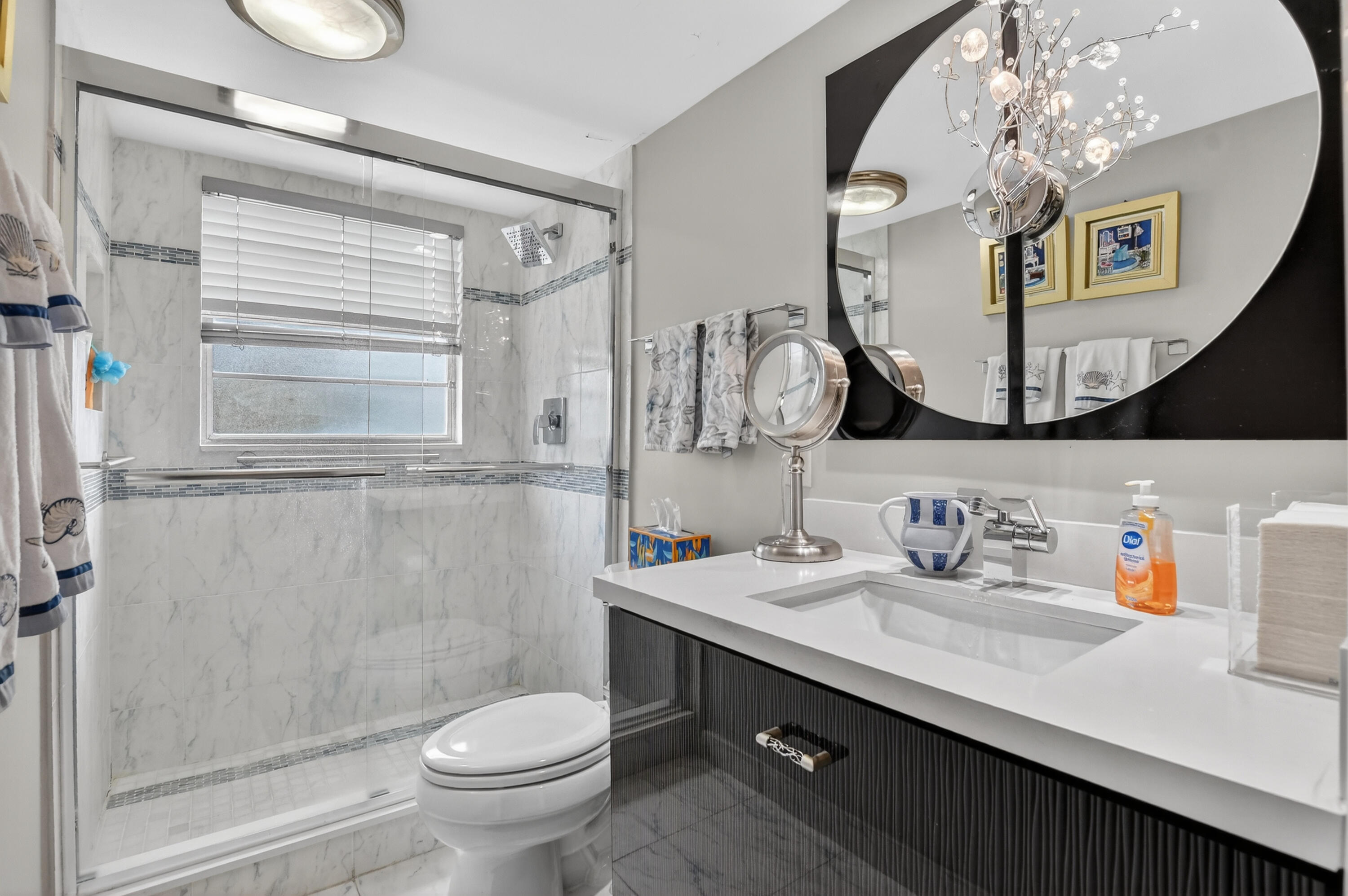 3080 Yarmouth C Boca Raton, FL 33434 - Photo 26 of 83 a bathroom with a sink a toilet and a mirror