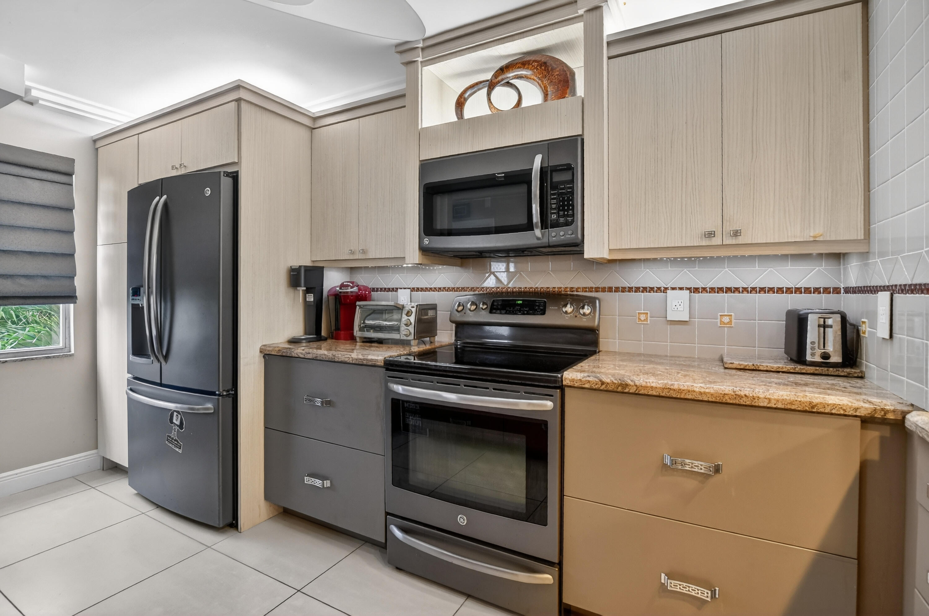 3080 Yarmouth C Boca Raton, FL 33434 - Photo 5 of 83 a kitchen with stainless steel appliances granite countertop a refrigerator stove and sink