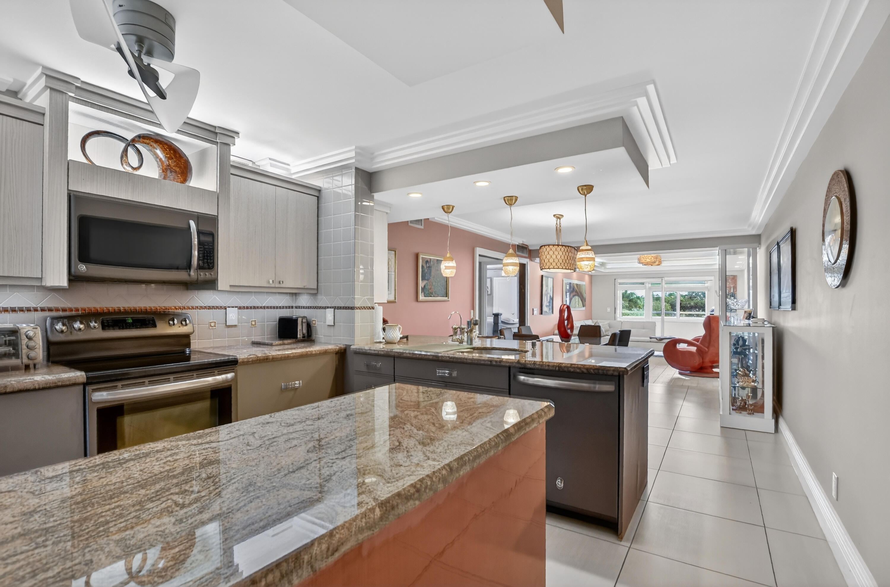3080 Yarmouth C Boca Raton, FL 33434 - Photo 6 of 83 a kitchen with kitchen island granite countertop a sink stove and cabinets