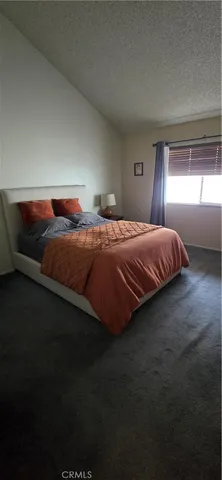 a living room with furniture and a lamp
