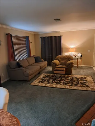 a living room with a fireplace and a flat screen tv