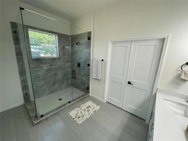a bathroom with a shower and a sink