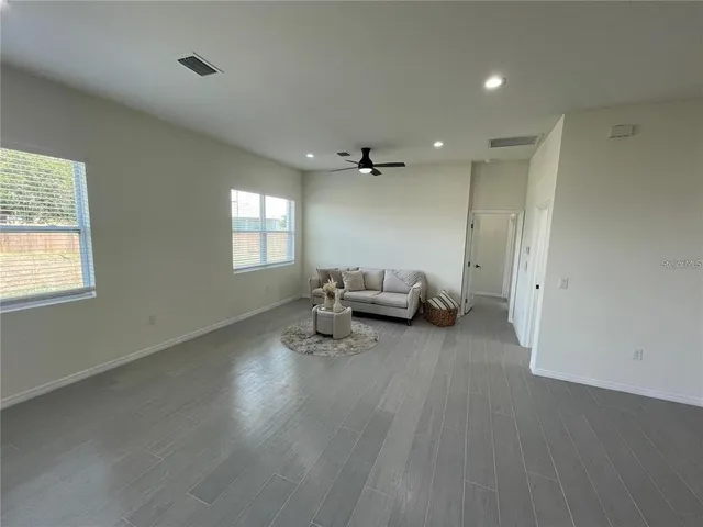 a view of a livingroom with furniture and a window