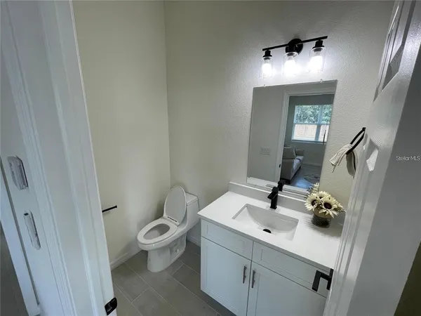 a bathroom with a sink toilet and mirror