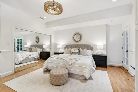 a bedroom with a bed and a chandelier