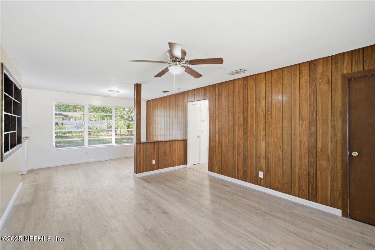 2142 Fouraker Road Jacksonville, FL 32210 - Photo 11 of 29 wooden floor in an empty room with a window