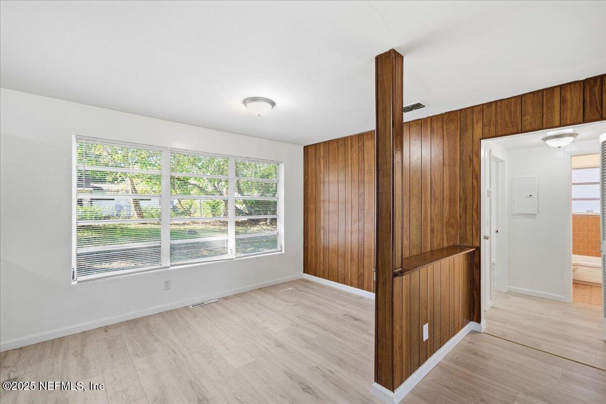2142 Fouraker Road Jacksonville, FL 32210 - Photo 12 of 29 a view of an empty room with wooden floor and a window