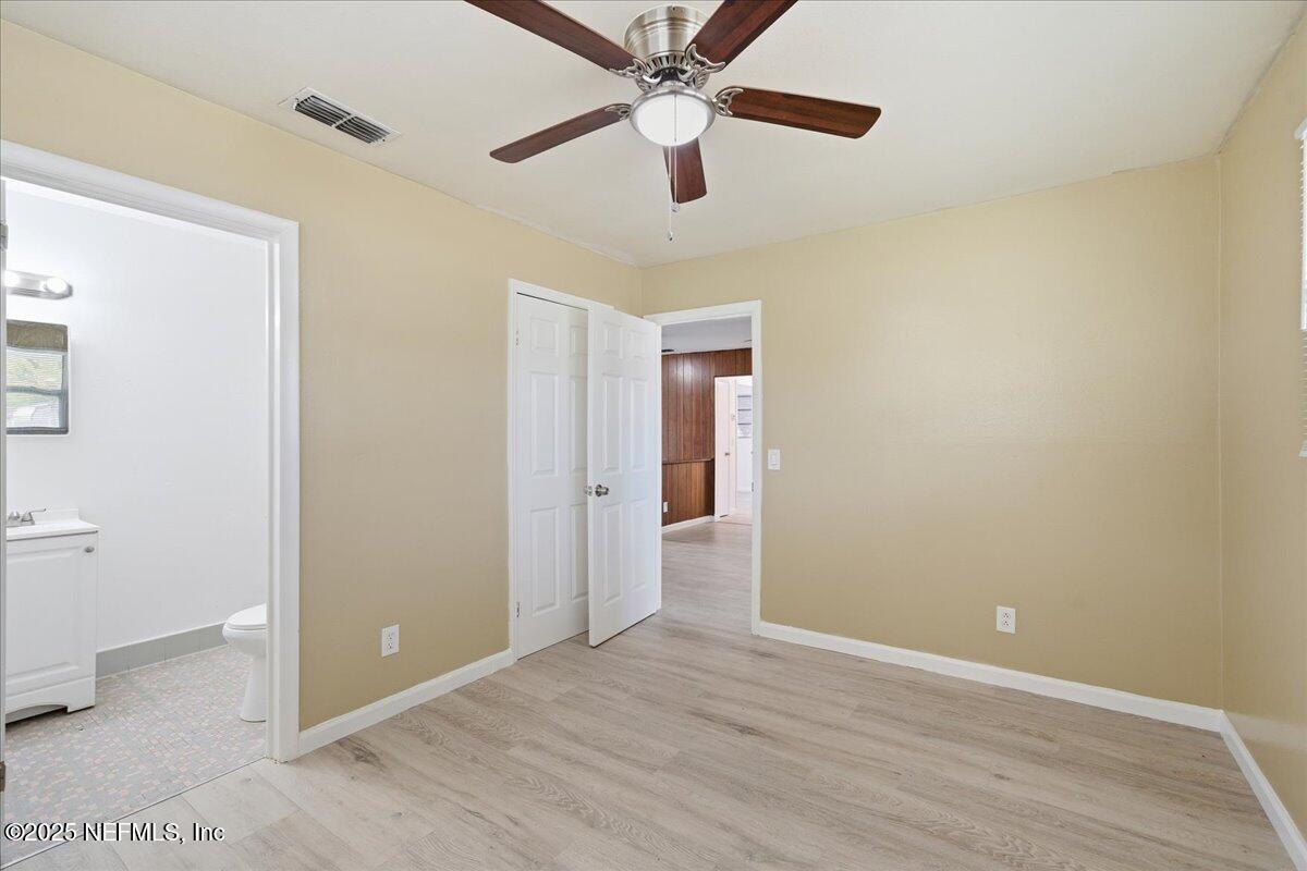 2142 Fouraker Road Jacksonville, FL 32210 - Photo 19 of 29 an empty room with closet and a ceiling fan