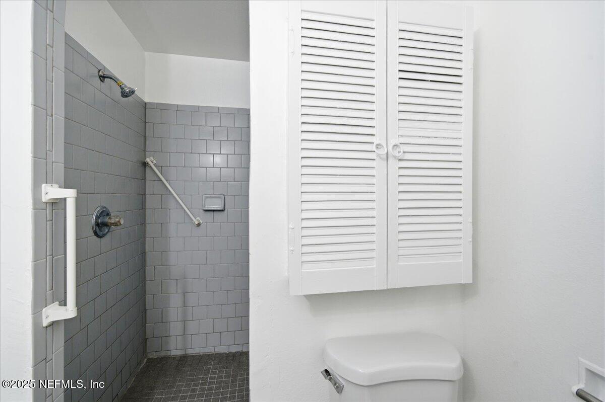 2142 Fouraker Road Jacksonville, FL 32210 - Photo 21 of 29 a bathroom with a window and a shower