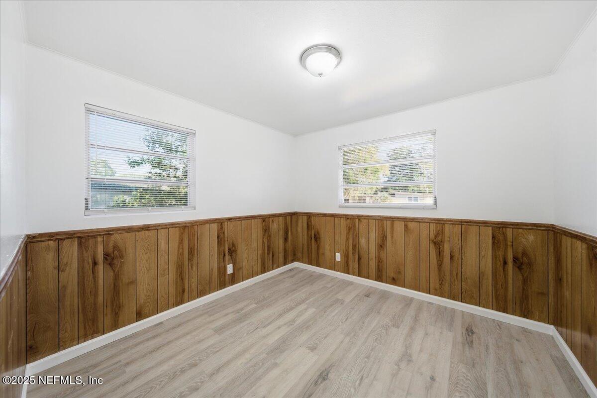 2142 Fouraker Road Jacksonville, FL 32210 - Photo 24 of 29 a view of wooden floor and windows in a room