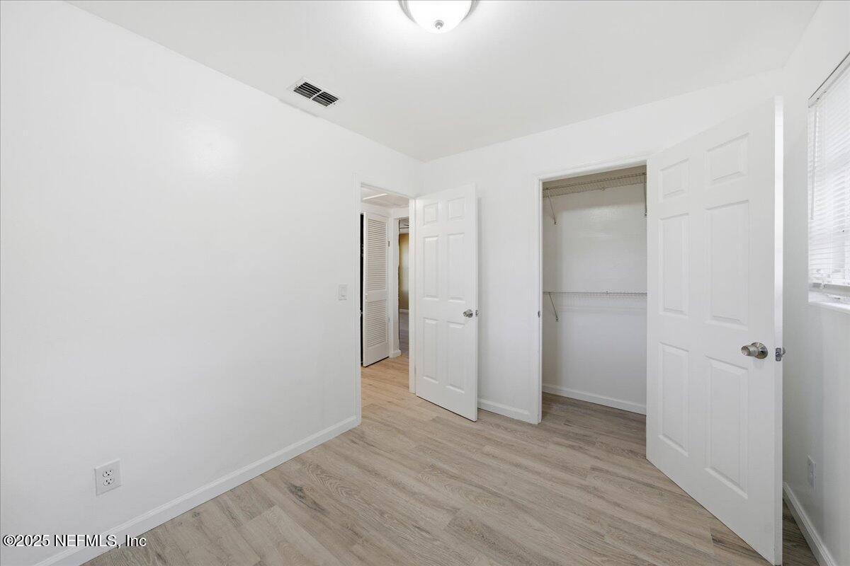 2142 Fouraker Road Jacksonville, FL 32210 - Photo 26 of 29 a view of an empty room with closet and a window