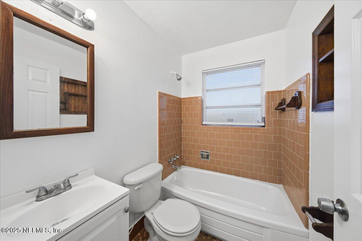 2142 Fouraker Road Jacksonville, FL 32210 - Photo 27 of 29 a bathroom with a sink toilet and shower
