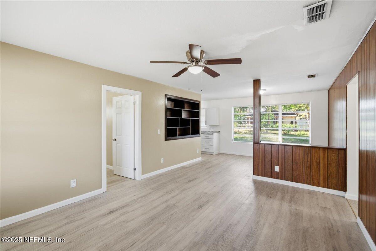 2142 Fouraker Road Jacksonville, FL 32210 - Photo 9 of 29 a view of a livingroom with wooden floor and a ceiling fan