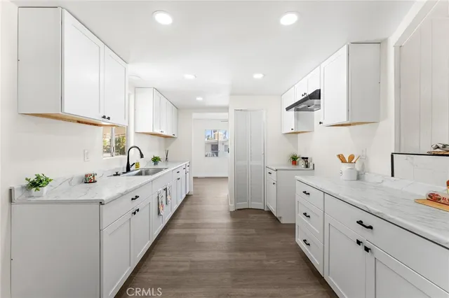 a kitchen with white cabinets sink and white appliances