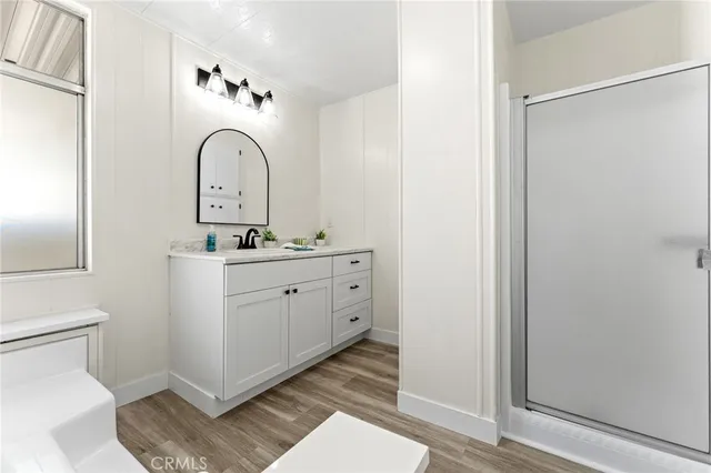 a bathroom with a sink mirror vanity and toilet