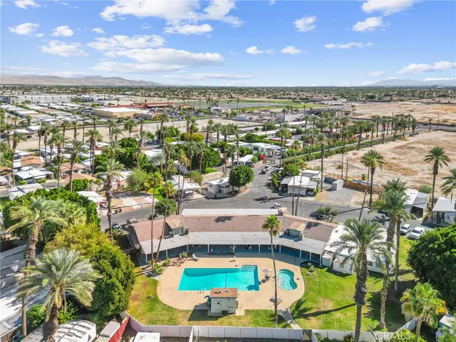 an aerial view of residential houses with outdoor space and swimming pool