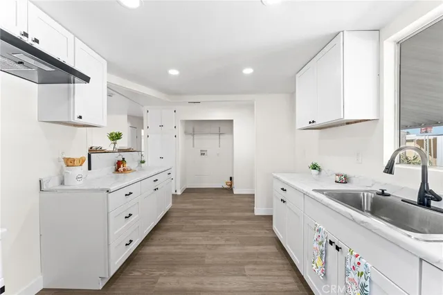 a kitchen with white cabinets sink and white appliances