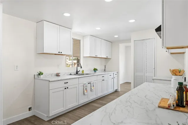 a kitchen with sink and cabinets