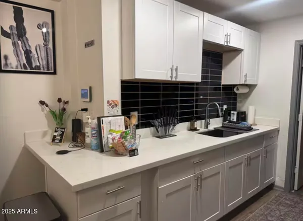 a kitchen with a sink and cabinets