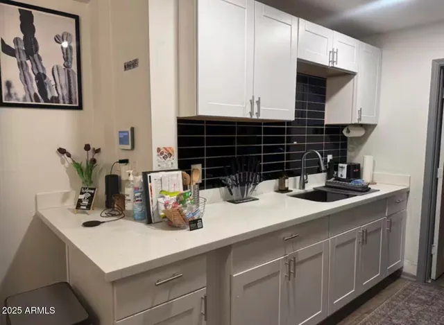 a kitchen with a sink and cabinets