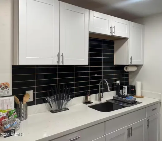 a kitchen with a sink and cabinets