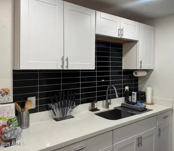 a kitchen with a sink and cabinets