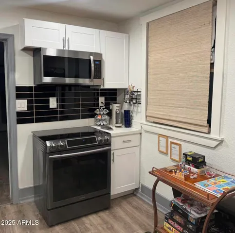 a kitchen with a stove and a microwave