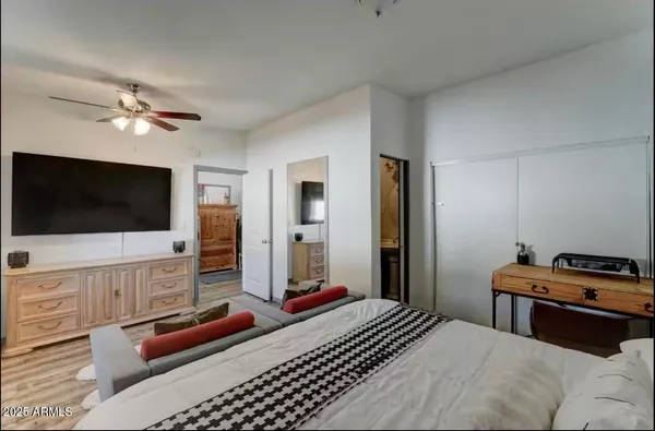 a bedroom with a bed and a flat screen tv