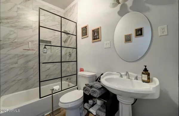a bathroom with a sink toilet and shower