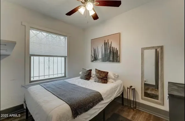 a bedroom with a large bed and a window