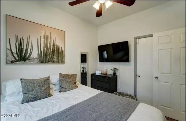 a bedroom with a bed and a flat screen tv